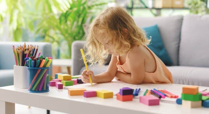 Cute girl coloring with markers