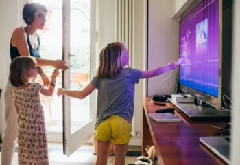 Family together indoor choosing videogame using game console