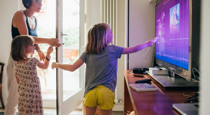 Family together indoor choosing videogame using game console