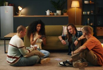Friends Playing Card Game in Cozy Living Room