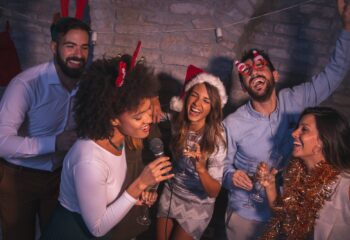 Friends singing karaoke at New Year's Eve party
