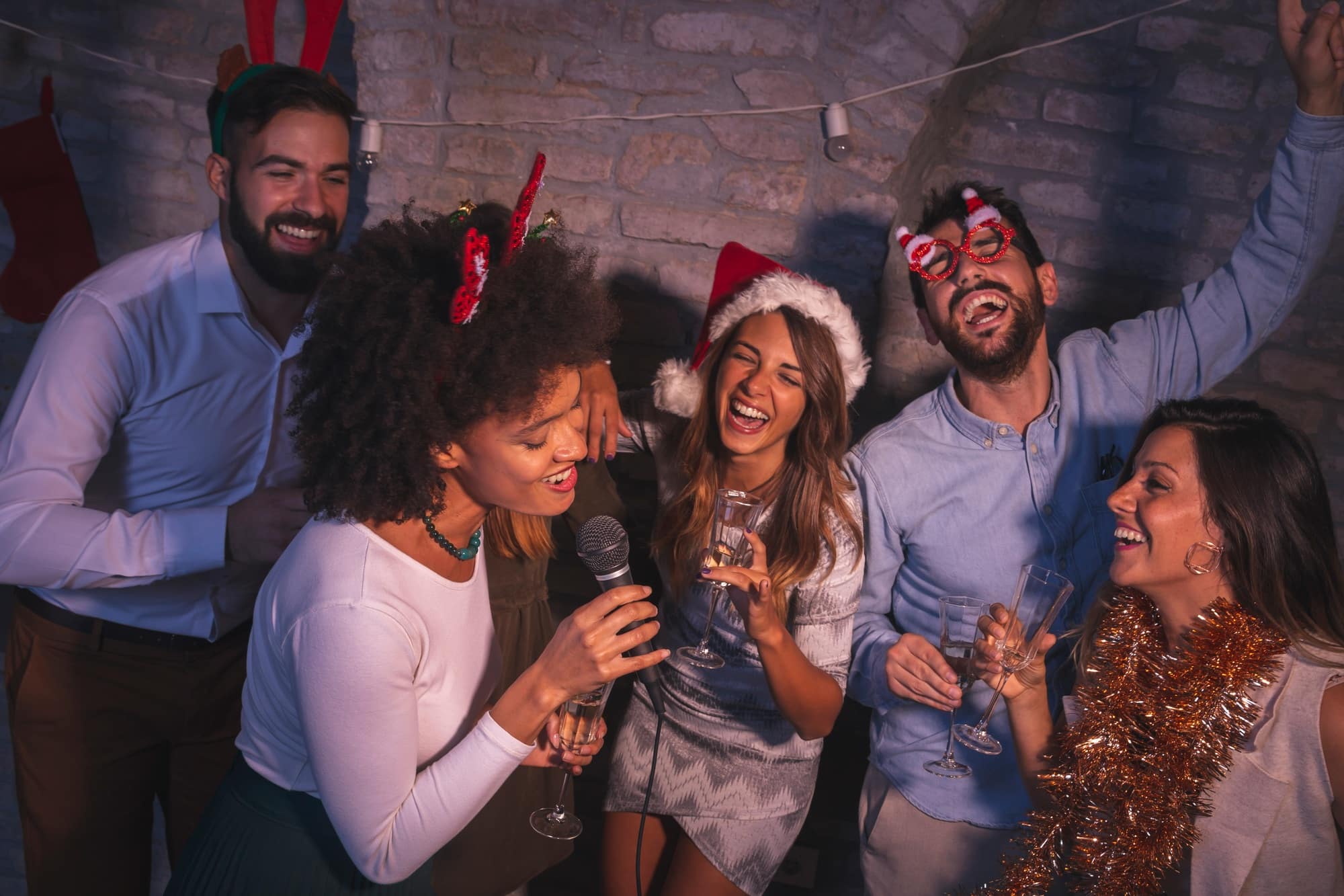 Friends singing karaoke at New Year's Eve party