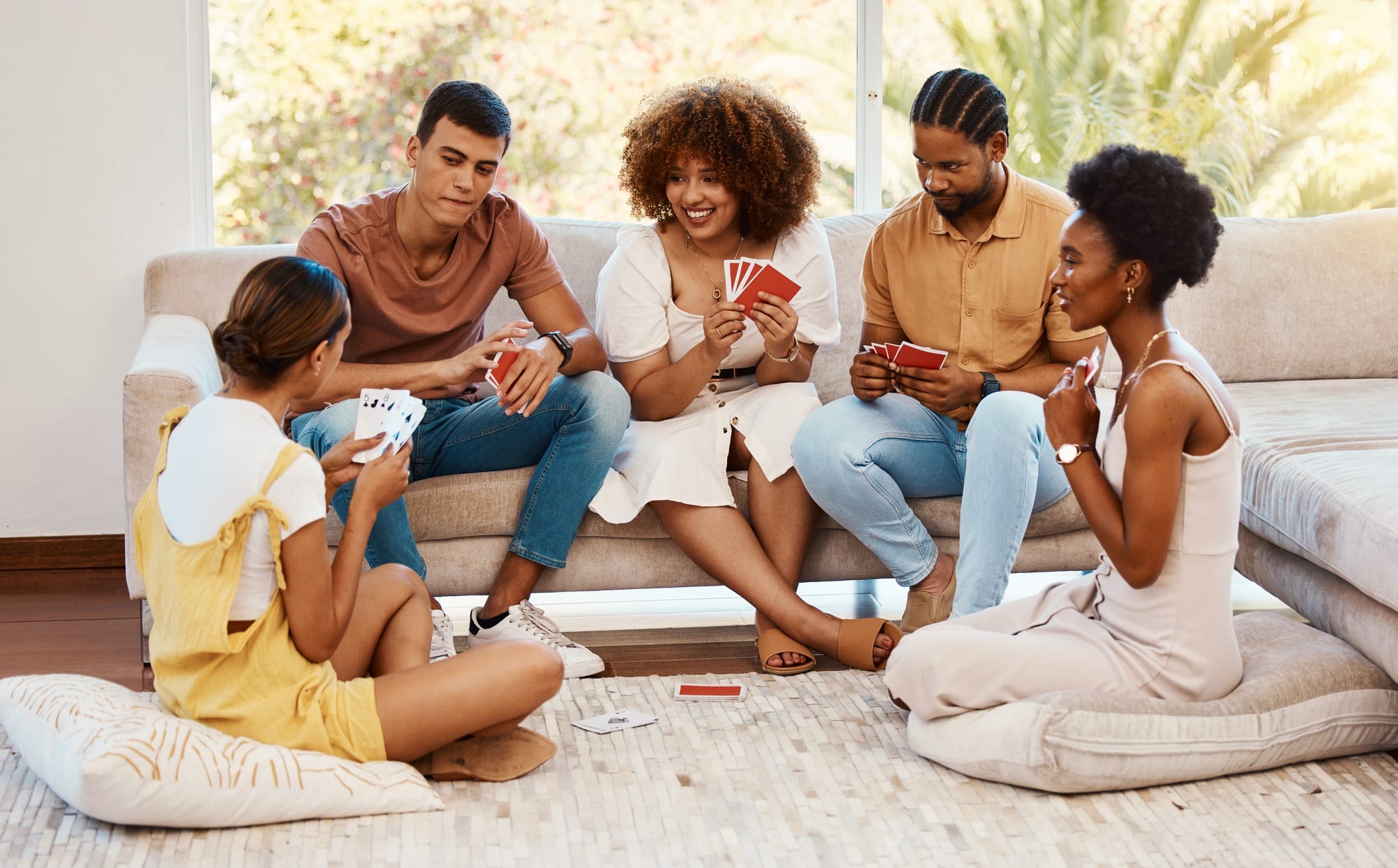 Game, smile or friends playing cards, poker or black jack at home for gambling together in a holida