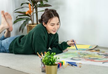 Professional female artist paints on canvas with brushes, Draw with watercolor, Drawing supplies