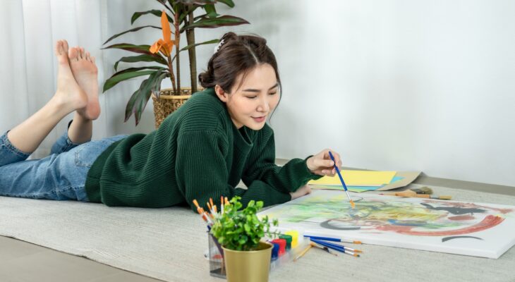 Professional female artist paints on canvas with brushes, Draw with watercolor, Drawing supplies
