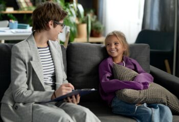 Social worker talking to child at home