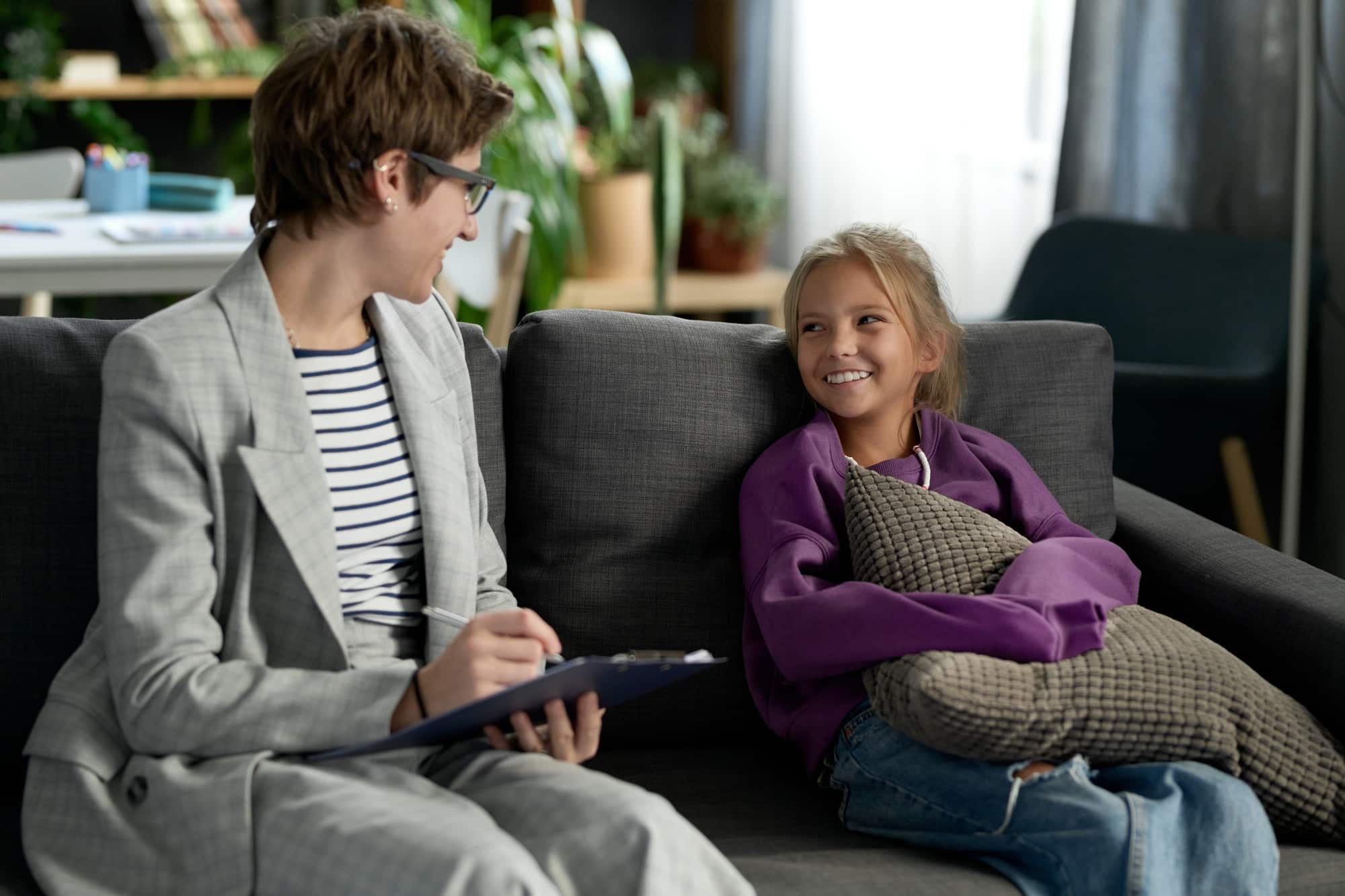Social worker talking to child at home