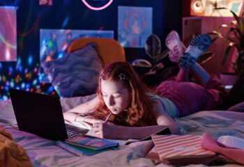 Teen Girl Doing Homework Late In Evening