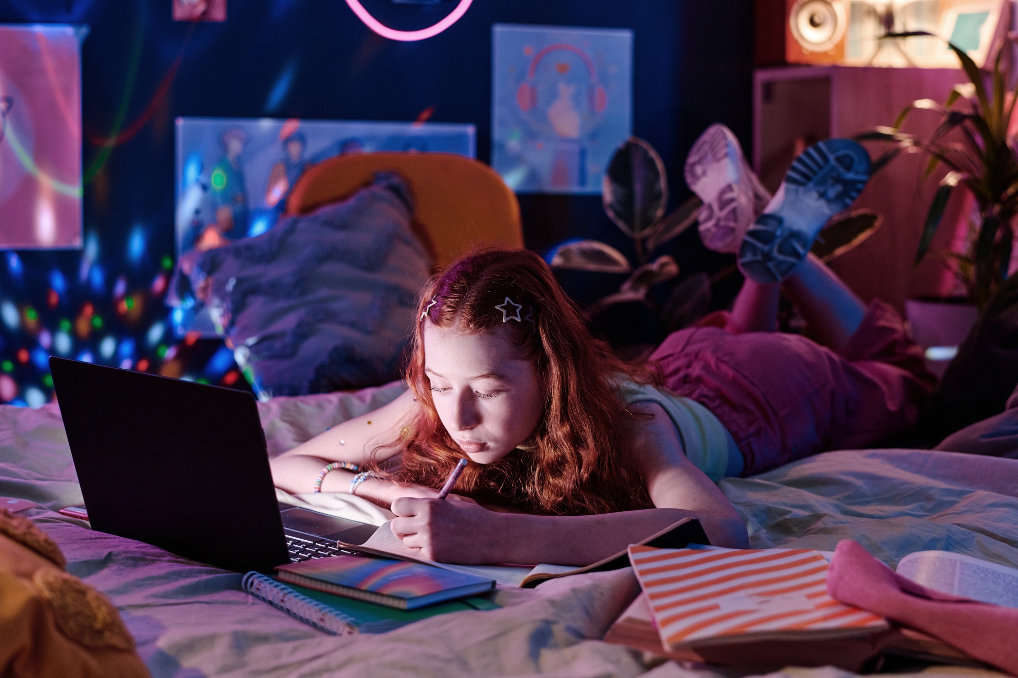 Teen Girl Doing Homework Late In Evening
