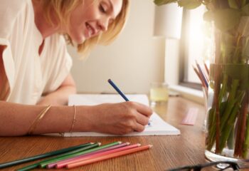 Woman coloring an adult coloring book with pencils