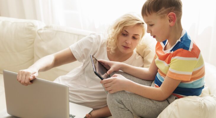 Boy is learning how to use a tablet pc