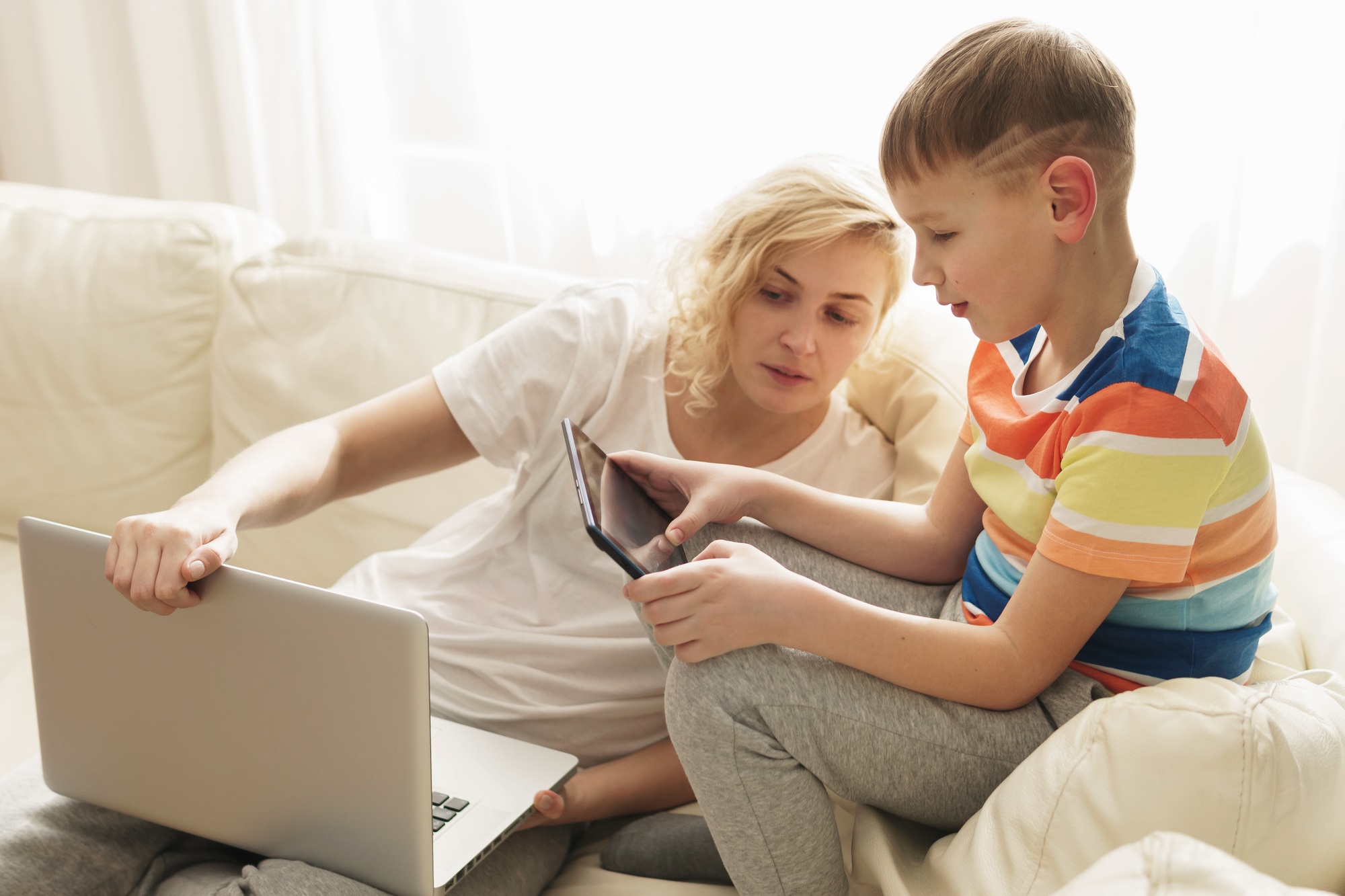 Boy is learning how to use a tablet pc